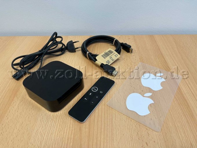 Apple TV mit Fernbedienung, Kabeln und Aufkleber