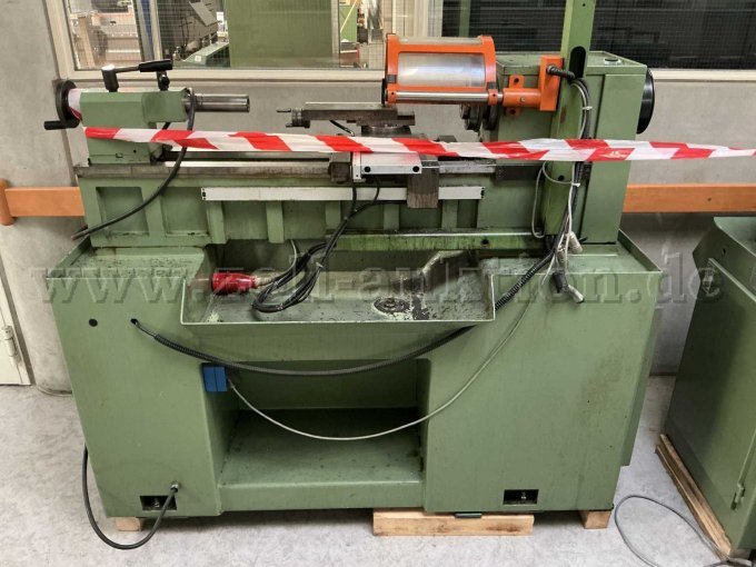 Ansicht der Maschine von vorne, es sind Verschmutzungen durch Betriebsstoffe und Farbabblätterungen in der Wanne zu erkennen.