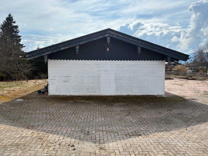 Zu sehen ist die Rückansicht der Hütte mit witterungsbedingter Abnutzung am Holz.