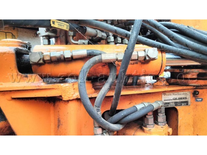 Schwenkzlinder mit beschädigten Hydraulik-Schlauchleitungen