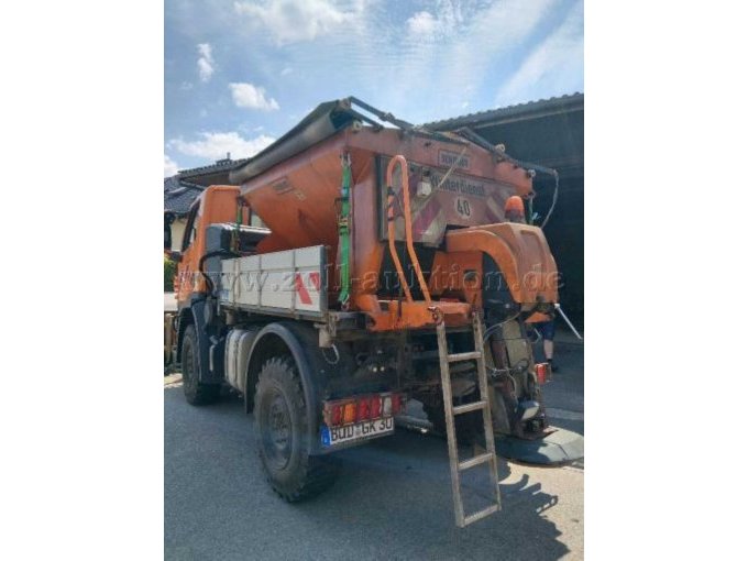Heck-/Seitenansicht des Unimog mit aufgebautem Schmidt-Salzstreuer.