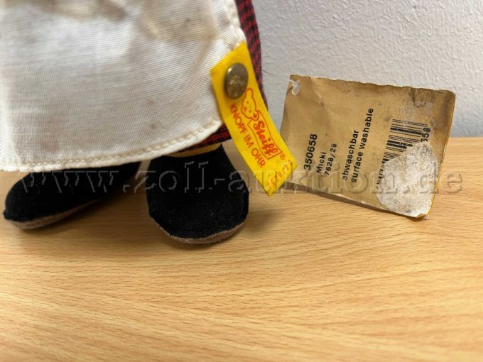 Stoff-Figur von Steiff "Micki", mit Knopf und Etikett.