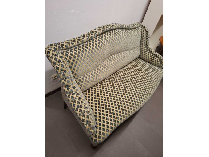 Vollgepolsterte Couch. Farbe beige-grau/blau. Leicht seitliche Sicht.